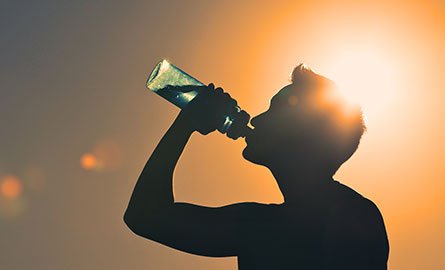 Silhouette of a person drinking water 